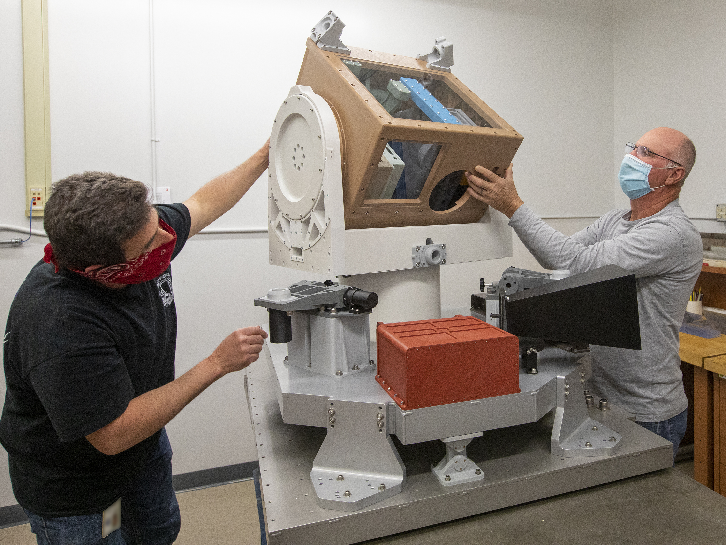 Mark Griffith and Robert Andrews working with the CLARREO Pathfinder model. Credits: NASA/Dave Bowman